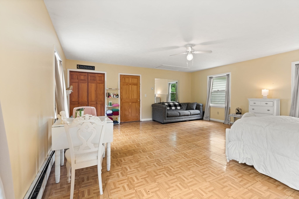 103 Renshaw Road Weare, NH 03281 - Photo 31 of 42 a living room with furniture and a chandelier