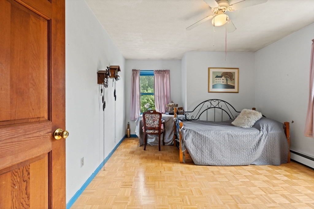 103 Renshaw Road Weare, NH 03281 - Photo 35 of 42 a living room with furniture and a chandelier