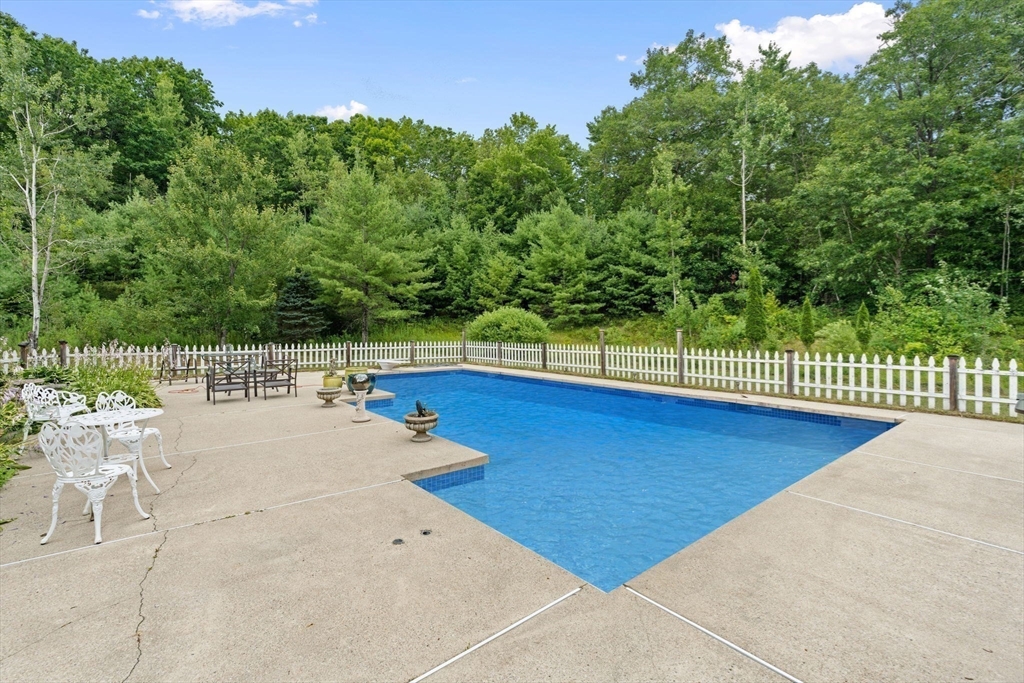 103 Renshaw Road Weare, NH 03281 - Photo 37 of 42 a view of a swimming pool with a lounge chair