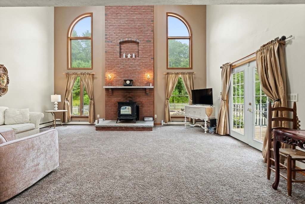 103 Renshaw Road Weare, NH 03281 - Photo 6 of 42 a living room with furniture a fireplace and a flat screen tv