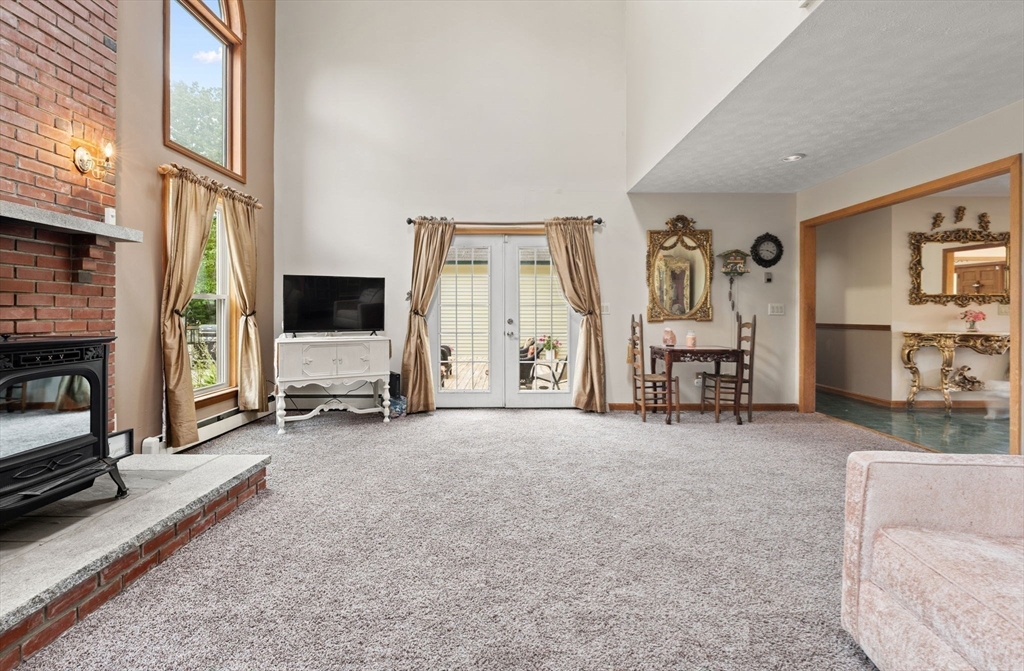 103 Renshaw Road Weare, NH 03281 - Photo 8 of 42 a view of a livingroom with furniture and a flat screen tv