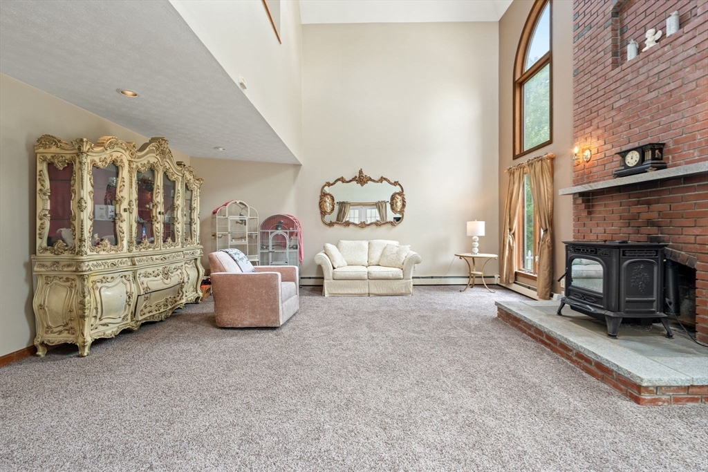 103 Renshaw Road Weare, NH 03281 - Photo 9 of 42 a living room with furniture and a fireplace