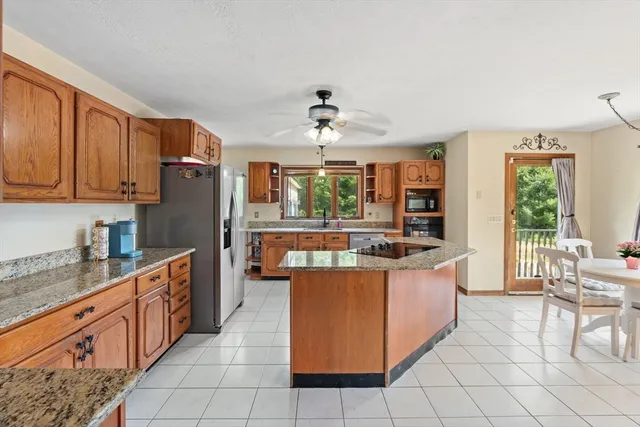 a kitchen with stainless steel appliances granite countertop a stove and a refrigerator