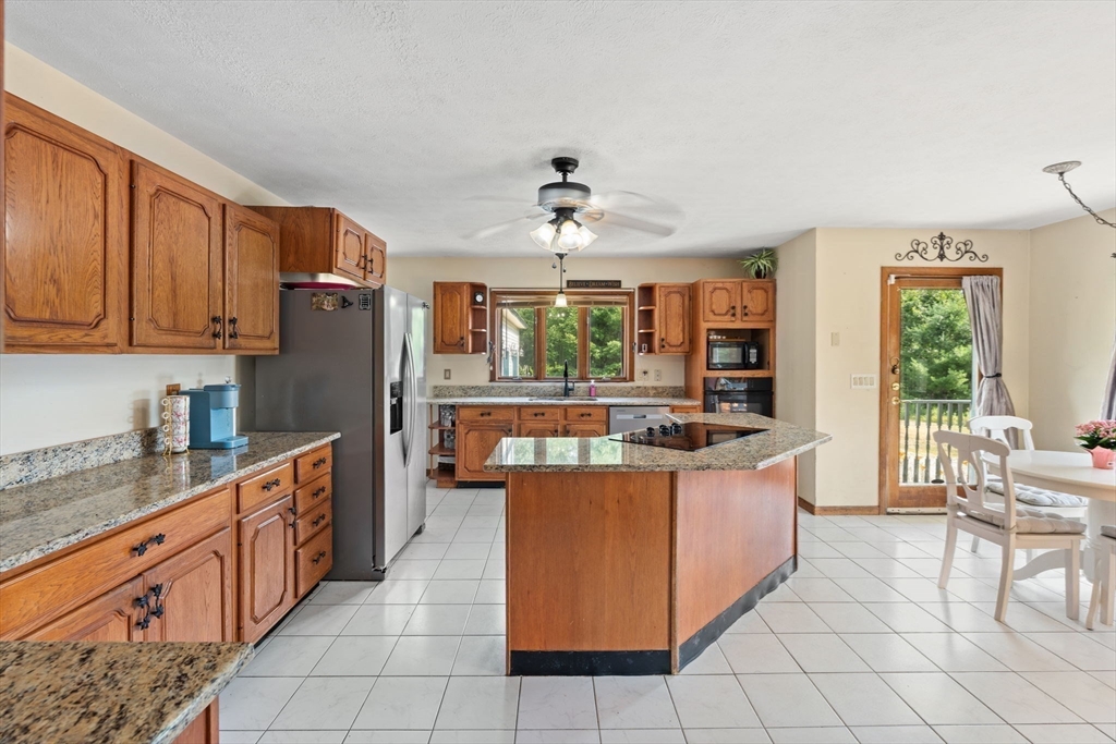 103 Renshaw Road Weare, NH 03281 - Photo 10 of 42 a kitchen with stainless steel appliances granite countertop a stove and a refrigerator