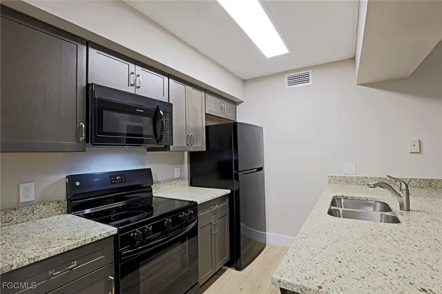 a kitchen with a refrigerator stove and microwave