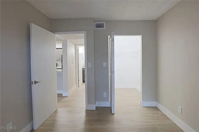 a view of a hallway with wooden floor