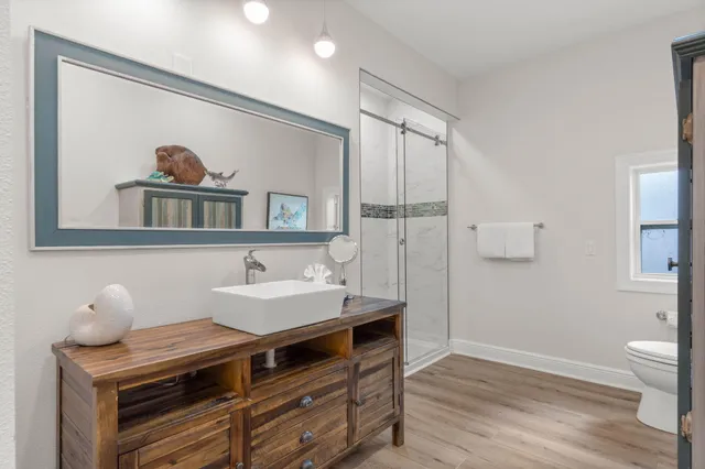 a bathroom with a tub shower vanity and sink