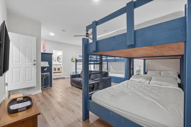 a living room with furniture and a ceiling fan