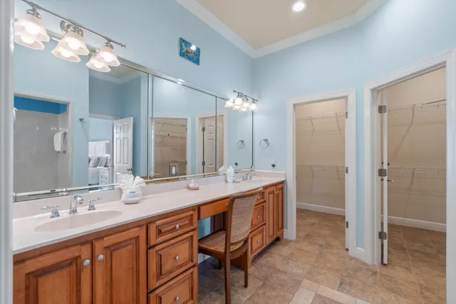 a bathroom with a granite countertop sink a toilet and a mirror