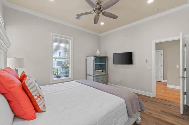 a kitchen with a stove a sink dishwasher a dining table and chairs with wooden floor