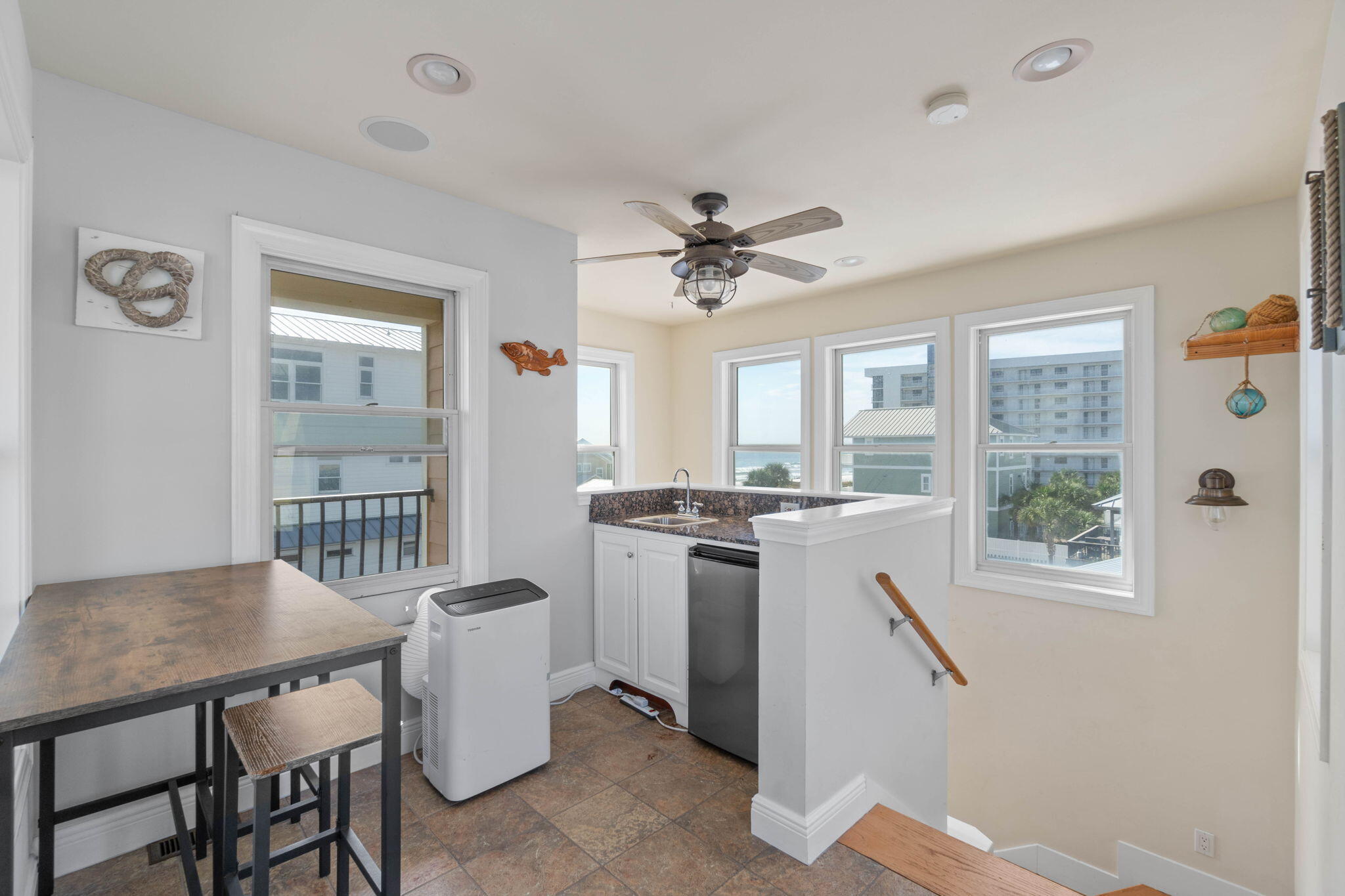 226 Sandtrap Road Miramar Beach, FL 32550 - Photo 53 of 63 a kitchen with a stove a sink dishwasher a dining table and chairs with wooden floor