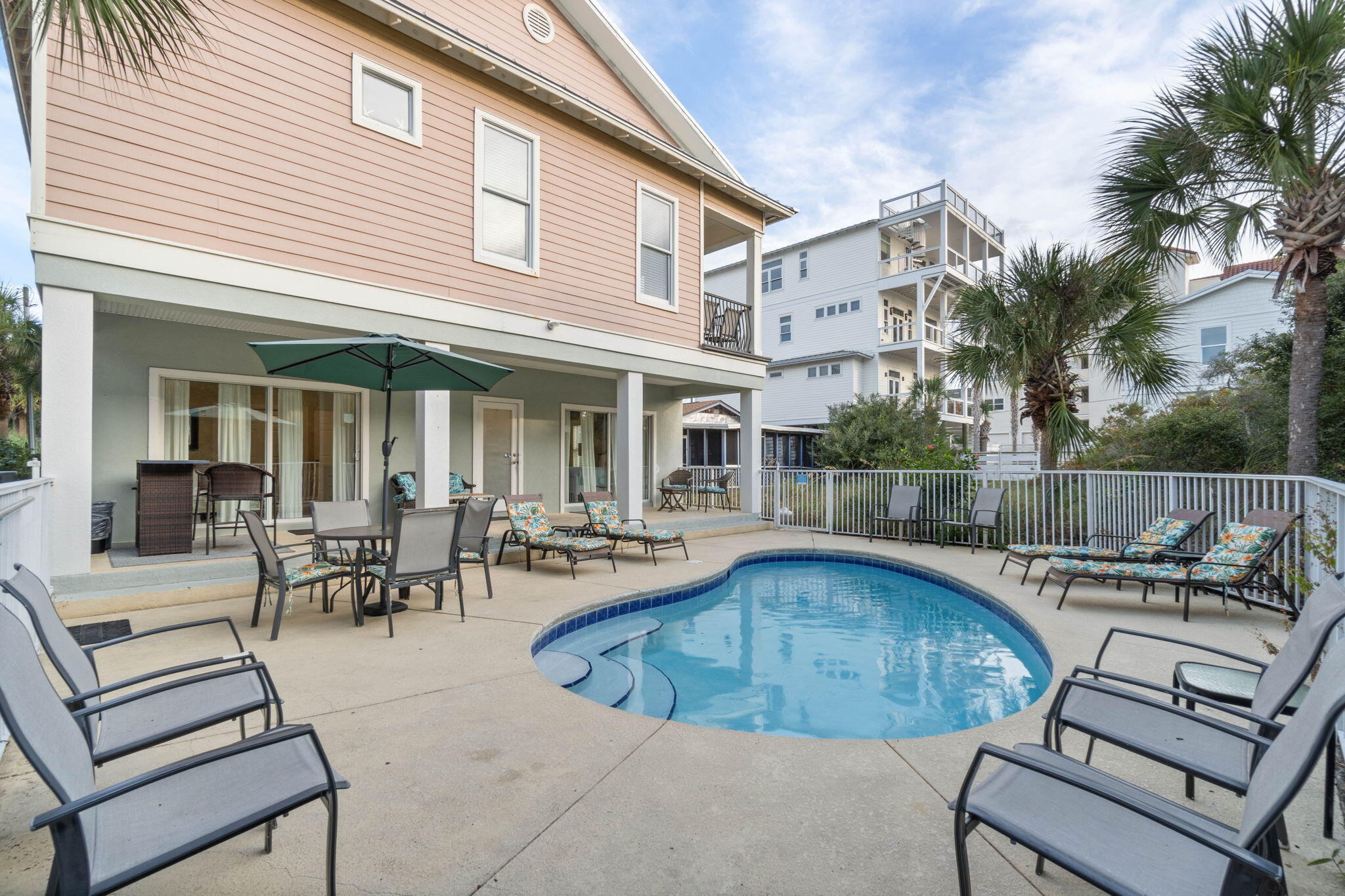 226 Sandtrap Road Miramar Beach, FL 32550 - Photo 58 of 63 a view of a white house with a swimming pool and sitting area