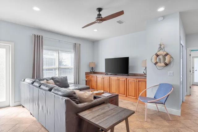 a living room with furniture and a kitchen
