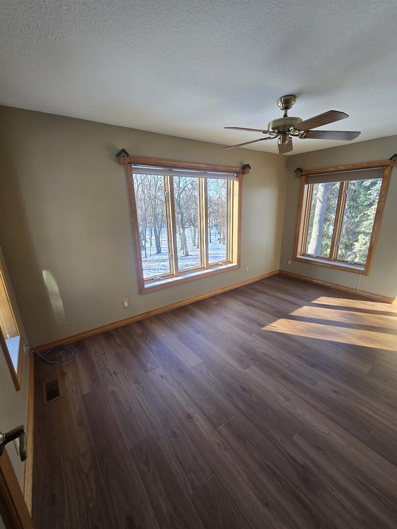 12719 Garden Plain Road Morrison, IL 61270 - Photo 29 of 85 a view of an empty room with a window and wooden floor