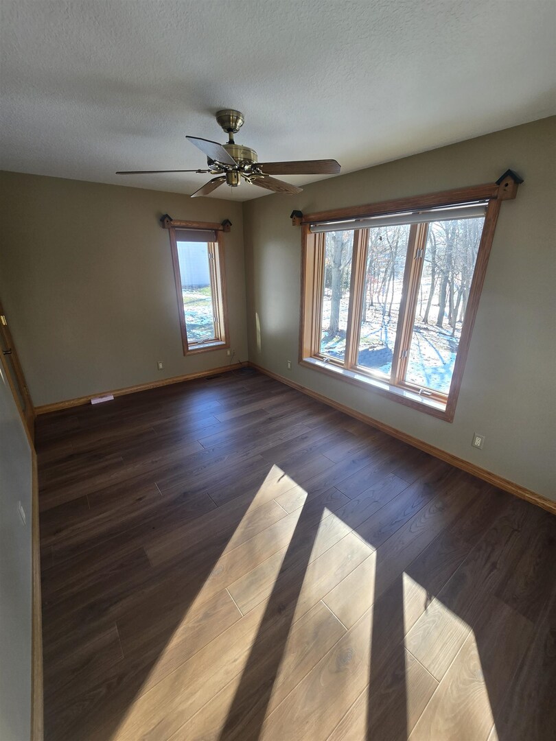 12719 Garden Plain Road Morrison, IL 61270 - Photo 31 of 85 a view of an empty room with wooden floor and a window
