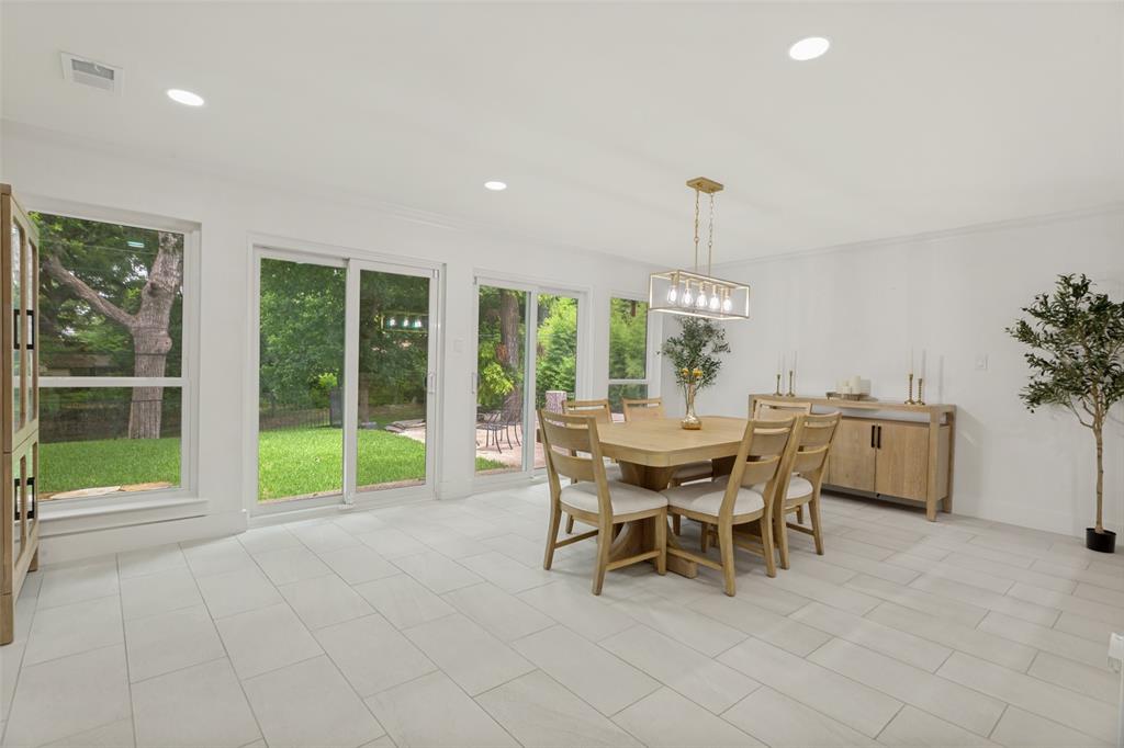4316 Springbranch Drive Benbrook, TX 76116 - Photo 15 of 39 Spacious living area featuring large windows, a sliding glass door, recessed lighting, and light-toned tile flooring
