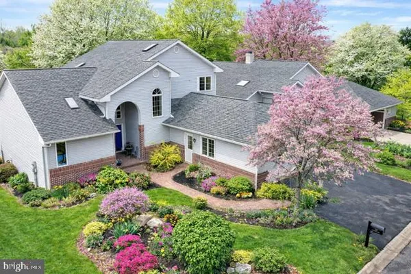 a aerial view of a house with a yard and garden