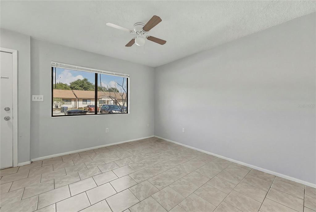 4799 Sisson Road Titusville, FL 32780 - Photo 4 of 23 an empty room with windows
