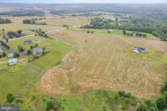 an aerial view of a house with outdoor space and lake view