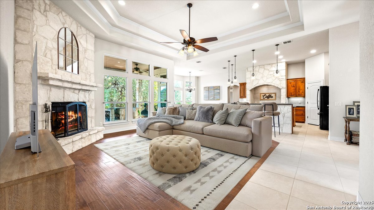8018 Canham Ranch Garden Ridge, TX 78266 - Photo 11 of 51 a living room with furniture fireplace and a chandelier
