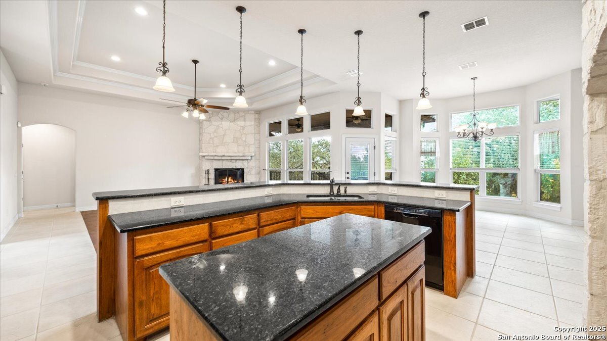 8018 Canham Ranch Garden Ridge, TX 78266 - Photo 15 of 51 a kitchen with stainless steel appliances granite countertop a stove a sink and kitchen island