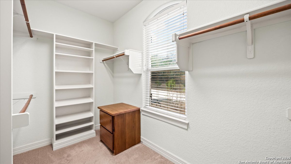8018 Canham Ranch Garden Ridge, TX 78266 - Photo 24 of 51 a view of walk in closet with empty racks