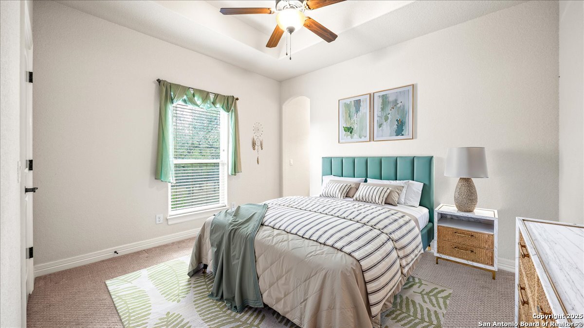 8018 Canham Ranch Garden Ridge, TX 78266 - Photo 26 of 51 a bedroom with a bed and a window
