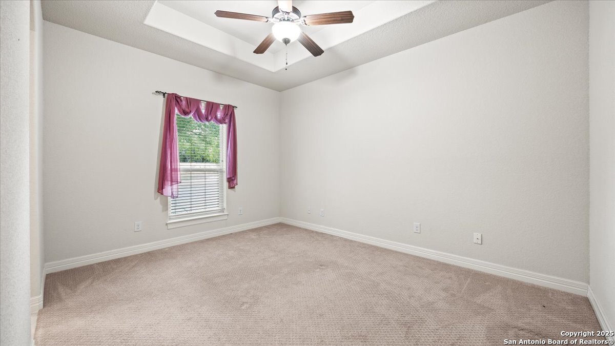 8018 Canham Ranch Garden Ridge, TX 78266 - Photo 29 of 51 an empty room with a ceiling fan and a window