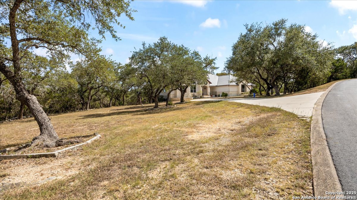 8018 Canham Ranch Garden Ridge, TX 78266 - Photo 3 of 51 a view of outdoor space with trees