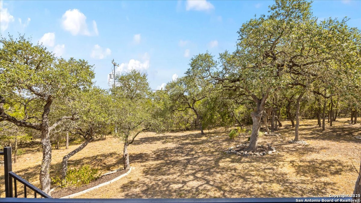 8018 Canham Ranch Garden Ridge, TX 78266 - Photo 35 of 51 a view of a yard with trees