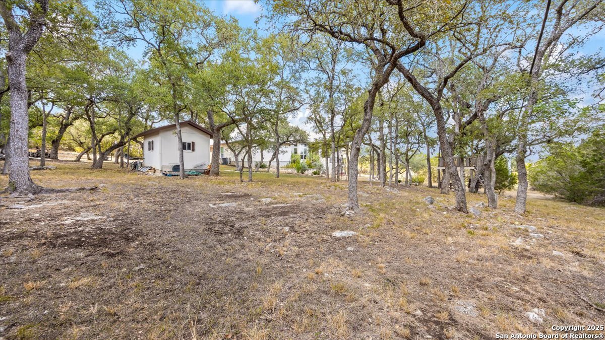 8018 Canham Ranch Garden Ridge, TX 78266 - Photo 39 of 51 a view of dirt yard with a house