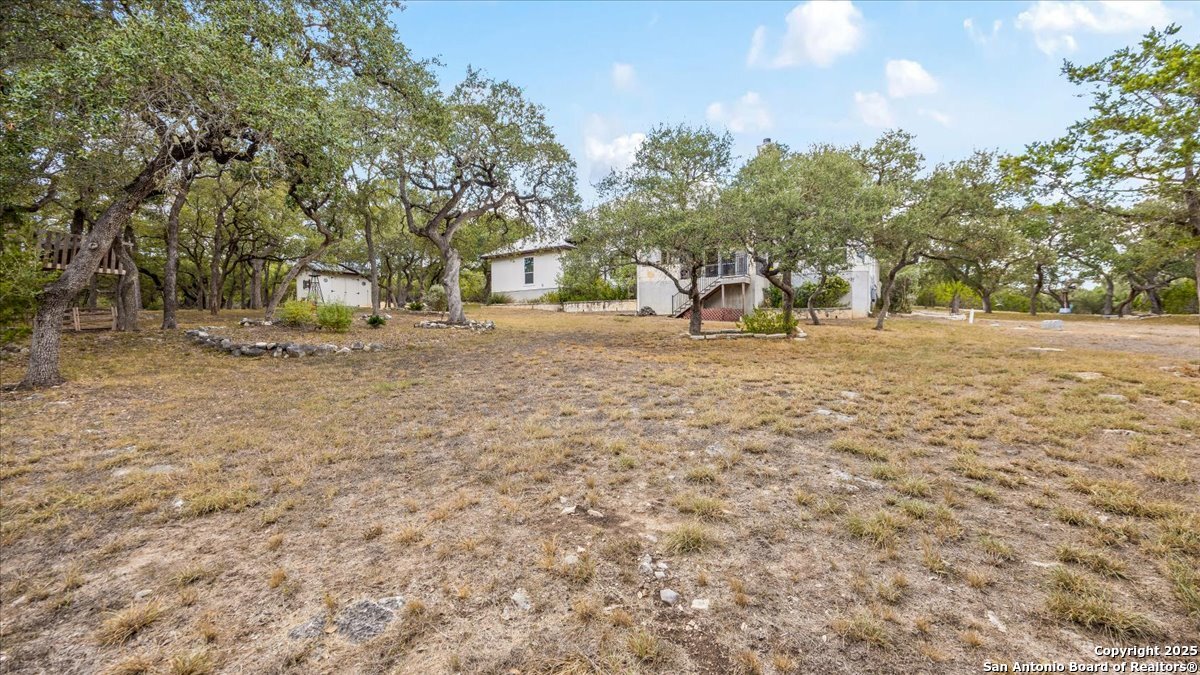 8018 Canham Ranch Garden Ridge, TX 78266 - Photo 40 of 51 a view of a yard with a house in the background