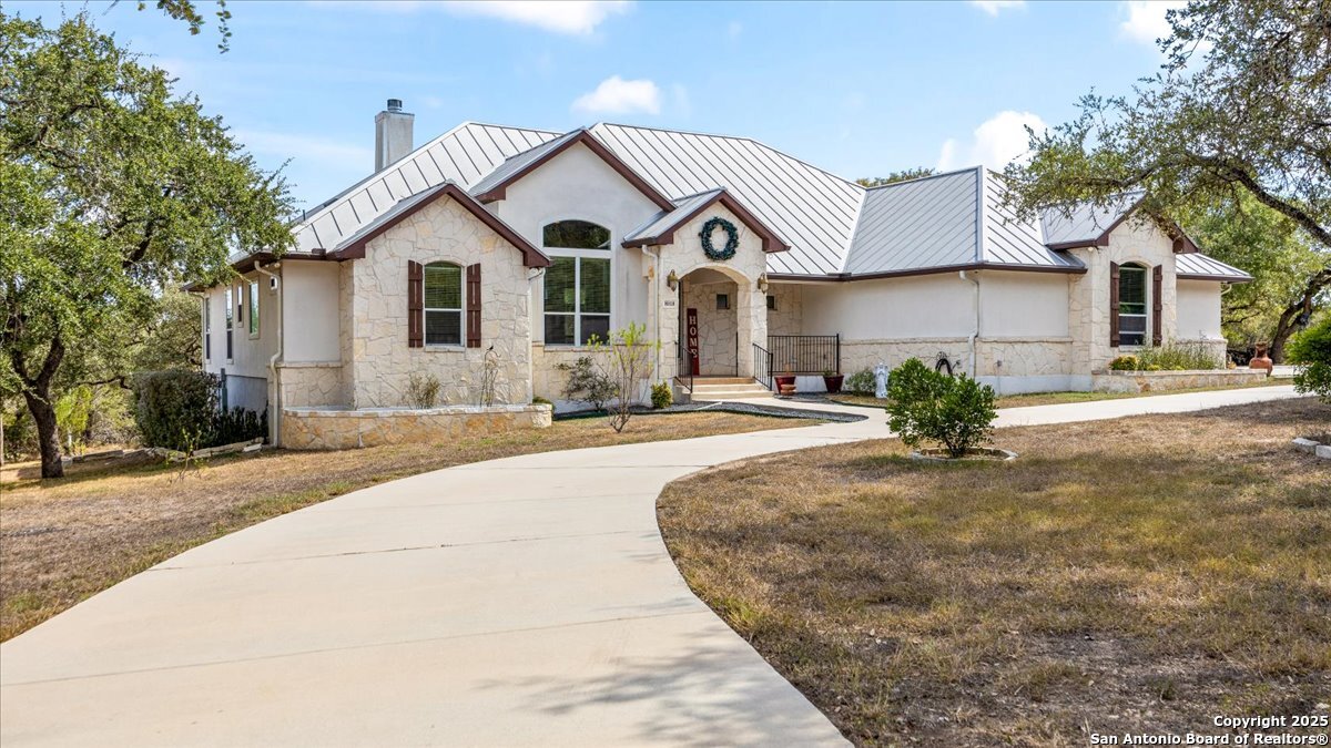 8018 Canham Ranch Garden Ridge, TX 78266 - Photo 4 of 51 a view of a white house with a yard
