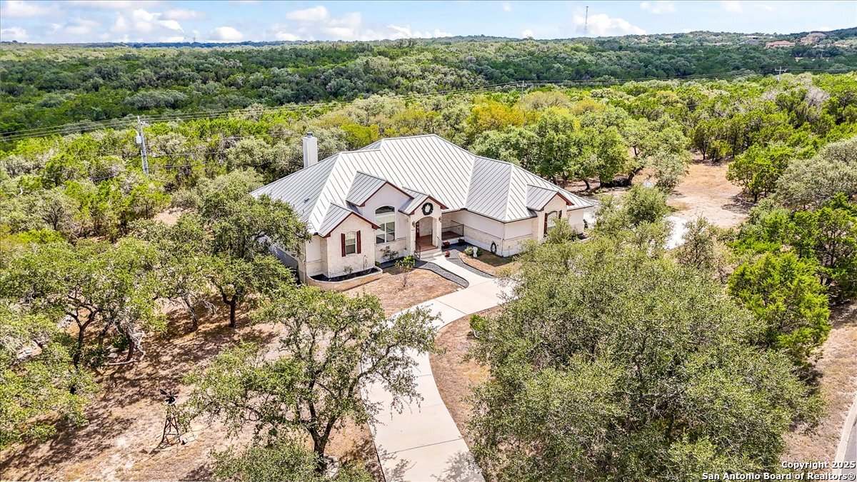 8018 Canham Ranch Garden Ridge, TX 78266 - Photo 46 of 51 a view of a lake with a yard and mountain in the background