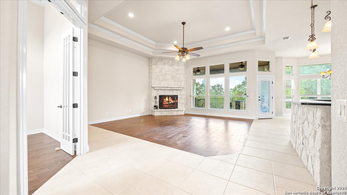 8018 Canham Ranch Garden Ridge, TX 78266 - Photo 6 of 51 a view of an empty room with a fireplace and a window