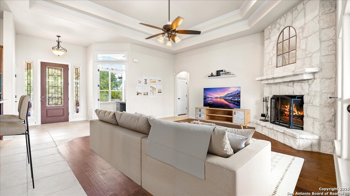 8018 Canham Ranch Garden Ridge, TX 78266 - Photo 9 of 51 a living room with furniture and a fireplace