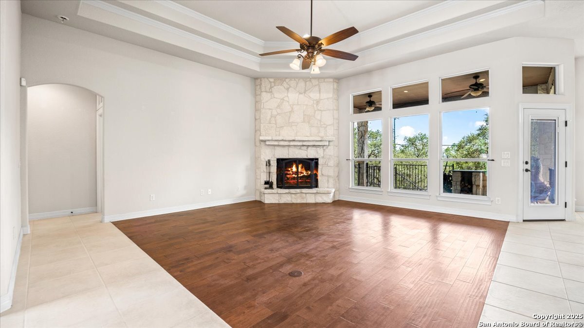 8018 Canham Ranch Garden Ridge, TX 78266 - Photo 10 of 51 a view of an empty room with wooden floor and a window