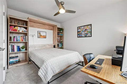 a bedroom with a bed and a book shelf
