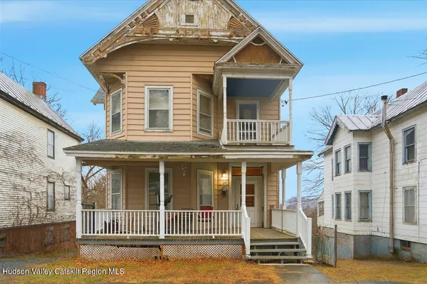 a view of a brick house with many windows