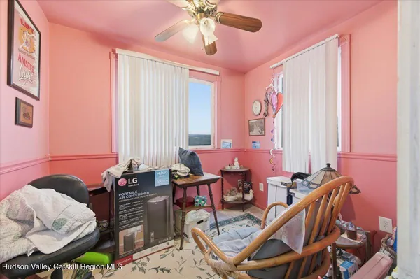 a dining room with furniture and a window