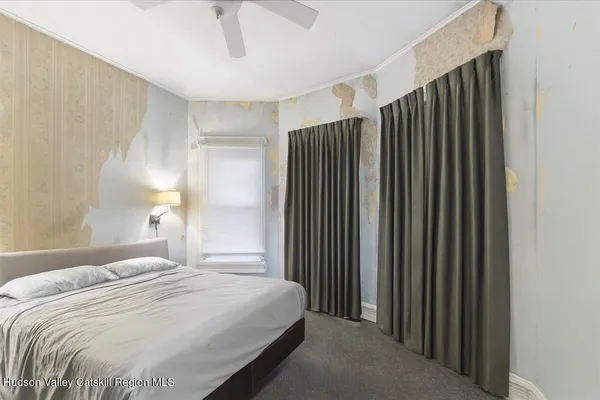 a bedroom with bed and a window