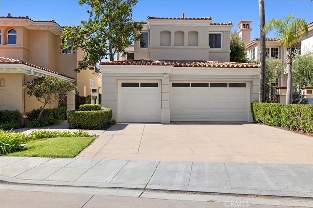 a view of white house with a yard and potted plants