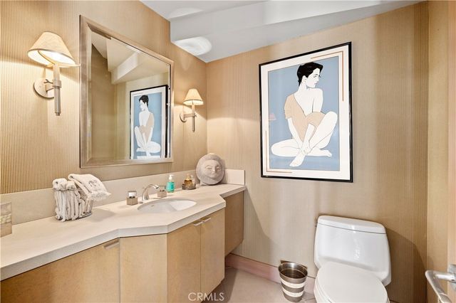 a bathroom with a granite countertop sink mirror and toilet