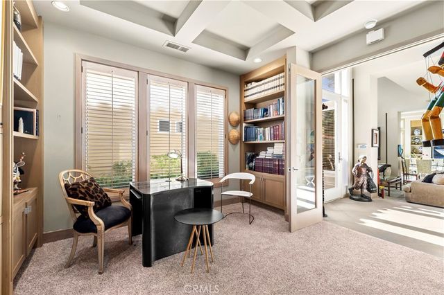 a view of a livingroom with workspace and a window