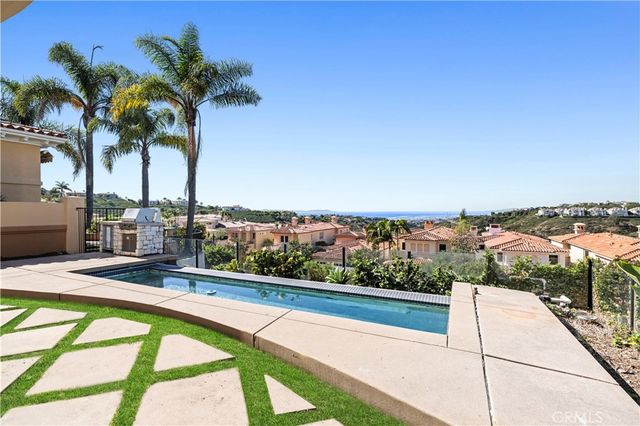 a view of swimming pool with a chairs