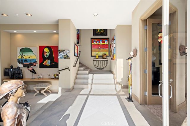 a living room with furniture a rug and white walls