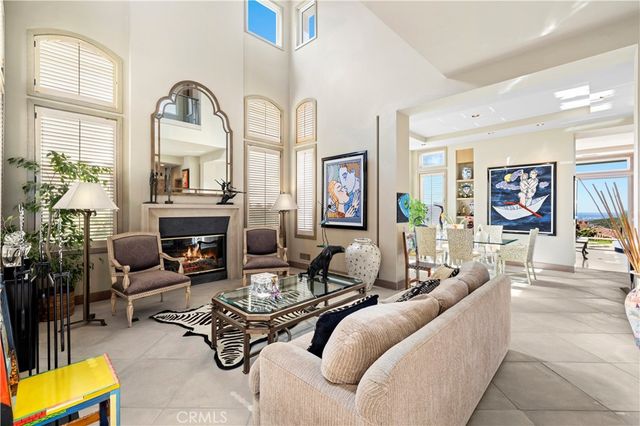 a living room with furniture flowerpot and a fireplace
