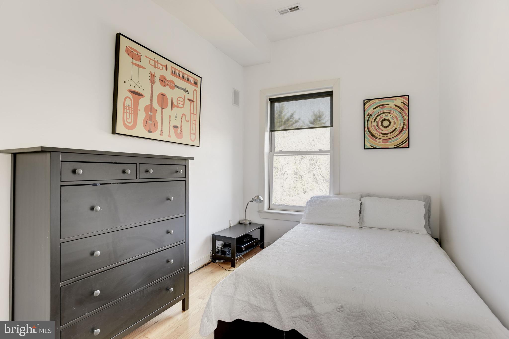1240 4th Street Northwest, Unit 200 Washington, DC 20001 - Photo 15 of 18 a bedroom with a bed and a window