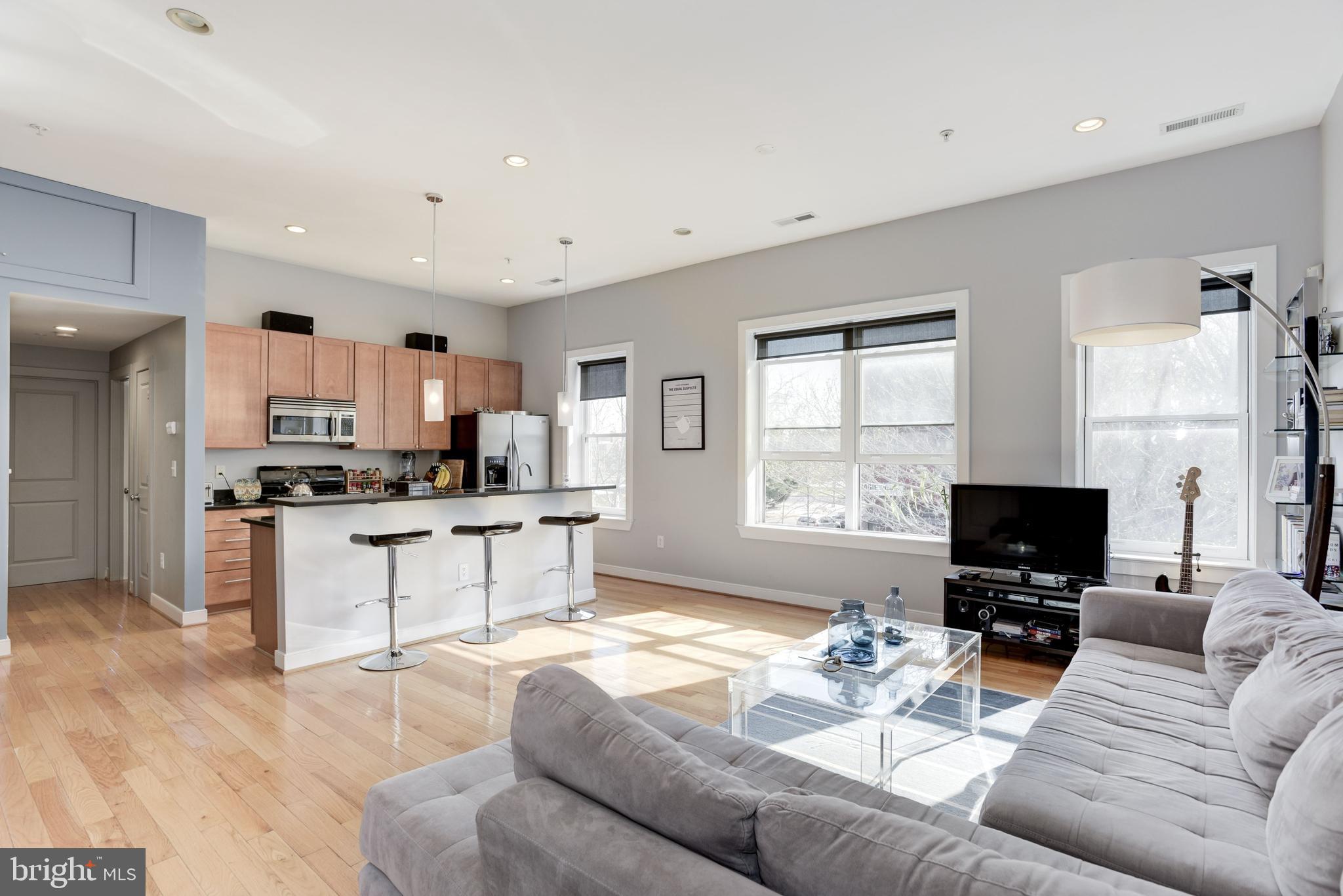 1240 4th Street Northwest, Unit 200 Washington, DC 20001 - Photo 2 of 18 a living room with furniture and a flat screen tv