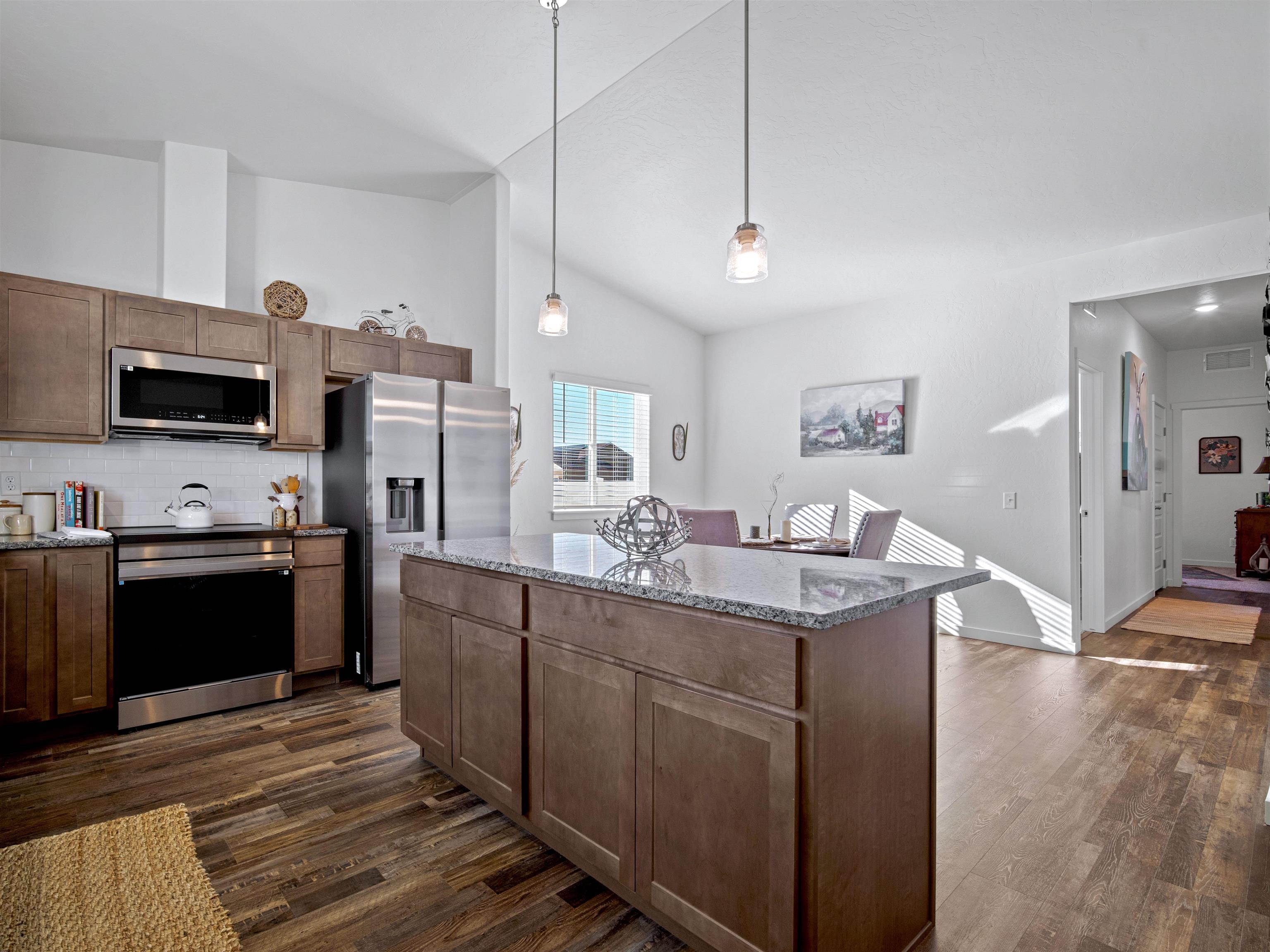 2147 Moon River Road Grand Junction, CO 81505 - Photo 12 of 34 a kitchen with stainless steel appliances kitchen island granite countertop a refrigerator a stove top oven a sink and dishwasher